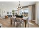 Light-filled dining room with wood floors, a modern chandelier, and sliding glass door at 17105 W 92Nd Loop, Arvada, CO 80007