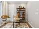 Bright home office with a glass desk, decorative shelving and a patterned rug at 17105 W 92Nd Loop, Arvada, CO 80007