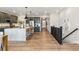 Open concept kitchen with stainless steel appliances, large island, and eat-in bar with pendant lighting at 17105 W 92Nd Loop, Arvada, CO 80007