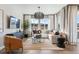 Cozy living room featuring large windows, wood floors, and comfortable seating at 17105 W 92Nd Loop, Arvada, CO 80007