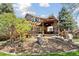 Outdoor living space with a custom deck, built-in grill, pergola, and stone accents at 6128 Songbird Cir, Boulder, CO 80303