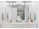 Bright bathroom with a double vanity, large mirror, and modern lighting fixtures at 6128 Songbird Cir, Boulder, CO 80303