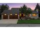 Charming two-story home with a brick exterior, mature trees, and a well-manicured lawn at 6128 Songbird Cir, Boulder, CO 80303