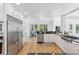Bright kitchen features stainless appliances, hardwood floors, white cabinetry and plenty of sunlight at 6128 Songbird Cir, Boulder, CO 80303