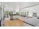 Modern white kitchen with hardwood flooring, stainless steel appliances, and abundant natural light at 6128 Songbird Cir, Boulder, CO 80303