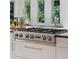 Close up of a modern stainless steel Jenn-Air gas range on a white kitchen island at 6128 Songbird Cir, Boulder, CO 80303
