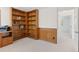 This office features custom wood built-ins, wainscoting, and carpet floors throughout at 6128 Songbird Cir, Boulder, CO 80303