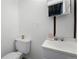 This bathroom features a sink, toilet and neutral walls at 5112 Duluth Ct, Denver, CO 80239