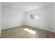 Light-filled bedroom with wood floors, a view of the back yard, and neutral paint at 5112 Duluth Ct, Denver, CO 80239