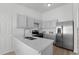 Bright kitchen with white cabinets, quartz countertops, stainless steel appliances, and modern fixtures at 5112 Duluth Ct, Denver, CO 80239