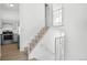 Stairway featuring modern wooden steps and white iron railing, connecting two floors of the home at 5112 Duluth Ct, Denver, CO 80239