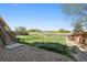 Backyard features a lawn, gravel area, stairs, and wooden fence, perfect for outdoor enjoyment at 12201 Village Cir, Brighton, CO 80603