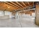 Unfinished basement with concrete floors and exposed wood ceiling, ready for customization at 12201 Village Cir, Brighton, CO 80603