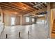 Spacious unfinished basement with exposed wood beams, offering potential for customization at 12201 Village Cir, Brighton, CO 80603