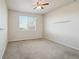 Bright bedroom with neutral carpet, ceiling fan, and a window allowing natural light at 12201 Village Cir, Brighton, CO 80603