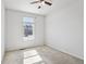 Neutral bedroom featuring soft carpet, a ceiling fan, and a view from the window at 12201 Village Cir, Brighton, CO 80603