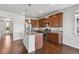 This kitchen has wood floors, granite counters, stainless appliances, and a central island at 12201 Village Cir, Brighton, CO 80603