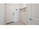 Bright laundry room with tile flooring, built-in shelf, and washer and dryer hookups at 12201 Village Cir, Brighton, CO 80603