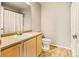 Simple bathroom with single sink, shower/tub combo, and neutral decor at 21621 Stoll Pl, Denver, CO 80249