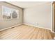 Simple bedroom with wood-look flooring and a window at 21621 Stoll Pl, Denver, CO 80249