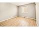 Bright bedroom with window, wood-look floors, and neutral walls at 21621 Stoll Pl, Denver, CO 80249