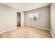 Well-lit bedroom featuring wood-look flooring and a closet at 21621 Stoll Pl, Denver, CO 80249