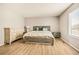 Bright bedroom featuring wood-look floors and a neutral color scheme at 21621 Stoll Pl, Denver, CO 80249