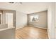 Well-lit bedroom with hardwood floors and access to a hallway at 21621 Stoll Pl, Denver, CO 80249