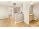 Light-filled hallway with laminate flooring, leading to bedrooms and a bathroom at 21621 Stoll Pl, Denver, CO 80249