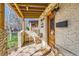 Inviting front porch with textured walls, rustic seating, and a decorative wood door at 2314 Dexter St, Denver, CO 80207