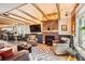 Comfortable living room showcasing a brick fireplace, exposed beams, and an open floor plan at 2314 Dexter St, Denver, CO 80207