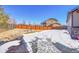 Landscaped backyard with snow, rock features, and fence at 77 N Irvington St, Aurora, CO 80018