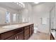 Double vanity bathroom with a shower and tile flooring at 77 N Irvington St, Aurora, CO 80018