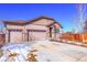 Two-car garage and front yard with landscaping at 77 N Irvington St, Aurora, CO 80018