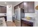 Open kitchen with large island, granite counters, and stainless steel appliances at 77 N Irvington St, Aurora, CO 80018