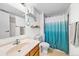 Functional bathroom with a shower stall, white fixtures, a wood vanity, and ample lighting at 13393 E Asbury Dr # 103, Aurora, CO 80014