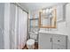 Bathroom featuring vanity with framed mirror, toilet, and shower with white curtain at 13393 E Asbury Dr # 103, Aurora, CO 80014