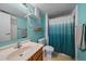 Bright bathroom with a stylish vanity, fresh blue walls, and a shower with a unique curtain design, perfect for relaxation at 13393 E Asbury Dr # 103, Aurora, CO 80014