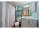 This bathroom features a pristine white sink and vanity, complemented by an eye-catching light blue accent wall at 13393 E Asbury Dr # 103, Aurora, CO 80014