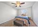 Cozy bedroom features ceiling fan, soft carpeting, and large window offering plenty of natural light at 13393 E Asbury Dr # 103, Aurora, CO 80014