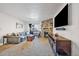 Inviting living room featuring a stone fireplace, large screen TV, comfortable seating, and access to a balcony at 13393 E Asbury Dr # 103, Aurora, CO 80014
