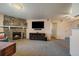 Spacious living room showcasing a stone fireplace and large entertainment center at 13393 E Asbury Dr # 103, Aurora, CO 80014