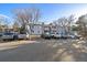 Parking lot with several parked cars in front of two story apartments with balconies at 13393 E Asbury Dr # 103, Aurora, CO 80014