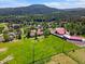 Scenic aerial view of homes nestled in a green landscape with mountain views at 8427 S Custer Ln, Evergreen, CO 80439
