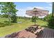 Inviting back deck with an umbrella-covered dining table, perfect for outdoor gatherings at 8427 S Custer Ln, Evergreen, CO 80439