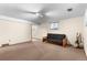 Spacious finished basement featuring neutral carpet, versatile layout and natural light at 8427 S Custer Ln, Evergreen, CO 80439