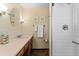 Bathroom with single vanity, framed mirror and shower at 8427 S Custer Ln, Evergreen, CO 80439