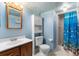 Cheerful bathroom featuring coordinated fixtures, walk-in shower and ample storage at 8427 S Custer Ln, Evergreen, CO 80439