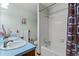 Bright bathroom featuring a dual sink vanity, tiled shower and tub, and modern fixtures at 8427 S Custer Ln, Evergreen, CO 80439