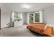 Sunlit bedroom with neutral carpet, large windows and a white dresser at 8427 S Custer Ln, Evergreen, CO 80439
